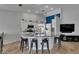 Open kitchen boasts white cabinetry, a center island with bar seating, and stainless steel appliances at 221 Lakeway Ln, Apollo Beach, FL 33572
