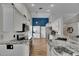 Contemporary kitchen with white cabinetry, stainless steel appliances, and granite countertops at 221 Lakeway Ln, Apollo Beach, FL 33572