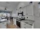 Modern kitchen with white cabinets, stainless steel appliances, and granite countertops for a luxurious feel at 221 Lakeway Ln, Apollo Beach, FL 33572