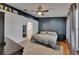 Spacious main bedroom featuring a decorative wall, ceiling fan, and wood floors at 221 Lakeway Ln, Apollo Beach, FL 33572
