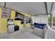 Covered patio boasts a TV, wet bar, ample seating, and access to the pool area at 221 Lakeway Ln, Apollo Beach, FL 33572