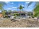 Enclosed swimming pool, surrounded by palms and tropical plants at 221 Lakeway Ln, Apollo Beach, FL 33572