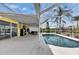 Spacious screened-in pool area with outdoor seating, lush greenery, and seamless indoor-outdoor living at 221 Lakeway Ln, Apollo Beach, FL 33572