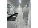Modern bathroom features a double vanity, sleek mirrors, and a glass-enclosed shower at 2528 Columbus S Way, St Petersburg, FL 33712