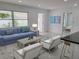 Cozy living room with a comfortable blue sofa and views to other rooms at 2528 Columbus S Way, St Petersburg, FL 33712