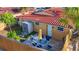 Aerial shot showcasing the outdoor patio space, with a table and chairs, and a red tile roof at 2600 N Paula Dr # 2B, Dunedin, FL 34698