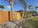 Wooden privacy fence runs along the property line, providing seclusion to the home's backyard at 2600 N Paula Dr # 2B, Dunedin, FL 34698