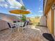 Patio featuring a table and chairs beneath an umbrella, surrounded by a fenced-in yard at 2600 N Paula Dr # 2B, Dunedin, FL 34698