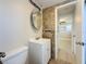 Charming renovated bathroom with a vanity, rounded mirror and tiled shower walls at 2600 N Paula Dr # 2B, Dunedin, FL 34698