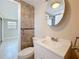 A renovated bathroom features tiled walls, a modern toilet, and a white vanity at 2600 N Paula Dr # 2B, Dunedin, FL 34698