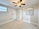 Bedroom with a ceiling fan, tile flooring, and window at 2600 N Paula Dr # 2B, Dunedin, FL 34698