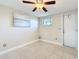 Bedroom featuring a ceiling fan, tile flooring, and access to outside of the home at 2600 N Paula Dr # 2B, Dunedin, FL 34698