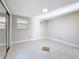 Bright bedroom features tile flooring, base molding, and window letting in plenty of natural light at 2600 N Paula Dr # 2B, Dunedin, FL 34698