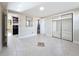 Spacious bedroom featuring tile floors, mirrored closet, and access to kitchen and bathroom at 2600 N Paula Dr # 2B, Dunedin, FL 34698