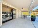 Convenient on-site laundry facility with modern appliances and adjacent outdoor seating area at 2600 N Paula Dr # 2B, Dunedin, FL 34698