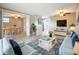 Bright and airy living room featuring stylish decor, tile floors, and a dining area at 2600 N Paula Dr # 2B, Dunedin, FL 34698