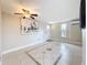 Well-lit living room with tile floors, ceiling fan, and view of front yard window at 2600 N Paula Dr # 2B, Dunedin, FL 34698