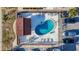 Bird's eye view of the community pool with lounge chairs, picnic tables, and lush tropical landscaping at 2600 N Paula Dr # 2B, Dunedin, FL 34698