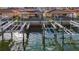 Elevated shot of the property's waterfront access, showcasing private boat slips on a sunny day at 2600 N Paula Dr # 2B, Dunedin, FL 34698