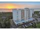 Stunning aerial view of condo building near the water at sunset with beautiful landscaping and covered parking at 2625 Terra Ceia Bay Blvd # 406, Palmetto, FL 34221