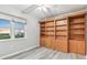Bright bedroom with a built-in bookcase, a ceiling fan, and a view of the outside sunset at 2625 Terra Ceia Bay Blvd # 406, Palmetto, FL 34221