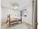 Bright bedroom with a ceiling fan, a full-size bed, and a view of the outside sunset at 2625 Terra Ceia Bay Blvd # 406, Palmetto, FL 34221