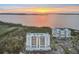 Aerial view of condo building with sunset in the background at 2625 Terra Ceia Bay Blvd # 406, Palmetto, FL 34221