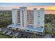 Exterior of large condo building surrounded by lush landscaping and a tranquil sunset backdrop at 2625 Terra Ceia Bay Blvd # 406, Palmetto, FL 34221