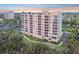 Stunning exterior shot of the condo with multiple balconies and a serene treed perimeter at 2625 Terra Ceia Bay Blvd # 406, Palmetto, FL 34221