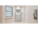 Hallway view of unit entry door numbered 406 and window to the exterior at 2625 Terra Ceia Bay Blvd # 406, Palmetto, FL 34221