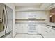 Bright kitchen with white cabinets, stainless steel refrigerator, and modern appliances at 2625 Terra Ceia Bay Blvd # 406, Palmetto, FL 34221