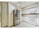 Well-lit kitchen featuring stainless steel appliances, white cabinetry, and tile flooring at 2625 Terra Ceia Bay Blvd # 406, Palmetto, FL 34221