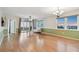 Bright living room featuring hardwood floors, a ceiling fan, and sliding glass doors to a balcony with sunset views at 2625 Terra Ceia Bay Blvd # 406, Palmetto, FL 34221