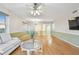 Bright living room area featuring hardwood floors, large windows, and a white couch for relaxing at 2625 Terra Ceia Bay Blvd # 406, Palmetto, FL 34221