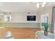 Open-concept living room with neutral color palette, hardwood floors, and adjacent pass-through bathroom at 2625 Terra Ceia Bay Blvd # 406, Palmetto, FL 34221
