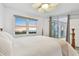 The main bedroom has a ceiling fan, a nice outside view, and sliding glass doors to the balcony at 2625 Terra Ceia Bay Blvd # 406, Palmetto, FL 34221