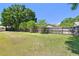 Large backyard with a well-maintained lawn, mature trees, and a sturdy wooden fence at 2914 Timber Knoll Dr, Valrico, FL 33596