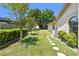 Lush backyard featuring well-maintained landscaping, mature trees, and a stone pathway at 2914 Timber Knoll Dr, Valrico, FL 33596