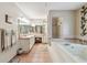 Bathroom features a large soaking tub, dual sinks, and glass shower at 2914 Timber Knoll Dr, Valrico, FL 33596