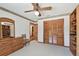 Neutral bedroom features neutral carpet, ceiling fan, dresser, and closet space at 2914 Timber Knoll Dr, Valrico, FL 33596