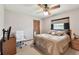 Comfortable bedroom features ceiling fan, neutral carpet, and wooden furniture at 2914 Timber Knoll Dr, Valrico, FL 33596