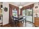 Charming dining area featuring a wooden table with bench seating and elegant drapery at 2914 Timber Knoll Dr, Valrico, FL 33596