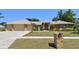 Charming brick home featuring a well-manicured lawn, a fountain, and a two-car garage at 2914 Timber Knoll Dr, Valrico, FL 33596