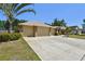 Spacious three-car garage with an extra wide driveway surrounded by manicured landscaping at 2914 Timber Knoll Dr, Valrico, FL 33596