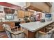 Open kitchen with a breakfast bar, wooden cabinetry, stainless steel appliances, and views into other living areas at 2914 Timber Knoll Dr, Valrico, FL 33596