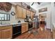 Functional kitchen featuring wooden cabinets, stainless steel appliances, and laminate wood flooring at 2914 Timber Knoll Dr, Valrico, FL 33596