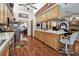 Well-lit kitchen featuring wooden cabinetry, stainless steel appliances, and an open view into the adjacent living room at 2914 Timber Knoll Dr, Valrico, FL 33596