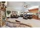 Open-concept living room with comfortable seating, a brick fireplace, and views into the kitchen and dining areas at 2914 Timber Knoll Dr, Valrico, FL 33596