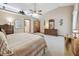 Large main bedroom with neutral carpet, tray ceiling, and furniture at 2914 Timber Knoll Dr, Valrico, FL 33596