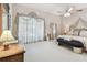 Bright and spacious main bedroom featuring elegant drapery, a ceiling fan, and plenty of natural light at 2914 Timber Knoll Dr, Valrico, FL 33596